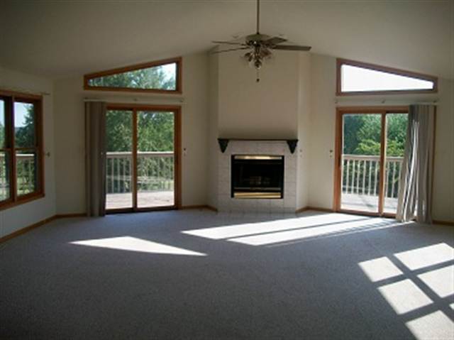 1229 Lake Summerset Road Davis, IL 61019 - Photo 4 of 7 a view of empty room with floor to ceiling window and fireplace