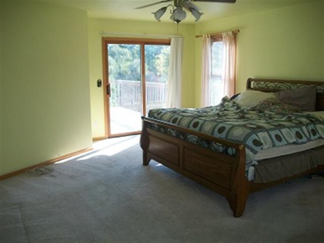 1229 Lake Summerset Road Davis, IL 61019 - Photo 5 of 7 a spacious bedroom with a bed and window
