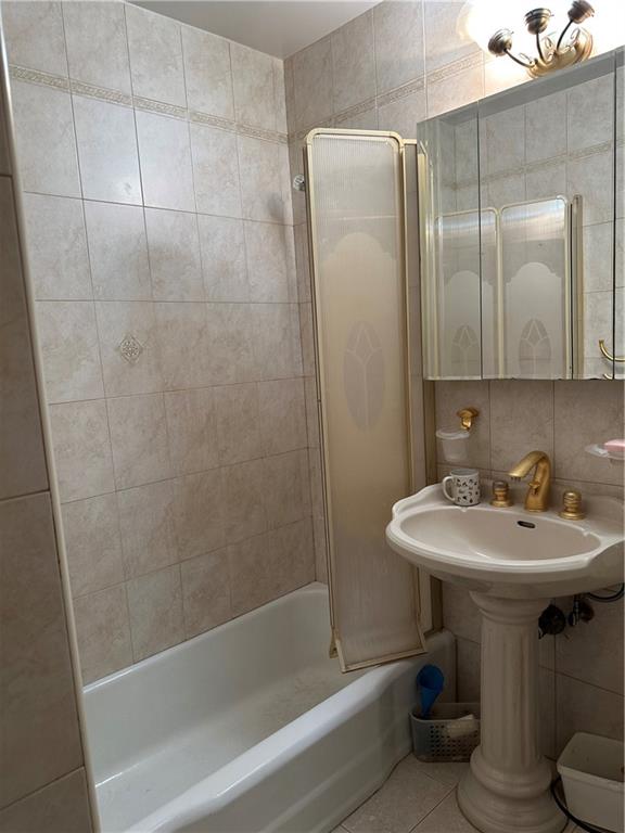 2935 West 5th Street, Unit 6D Brooklyn, NY 11224 - Photo 11 of 13 a bathroom with a sink a toilet and shower