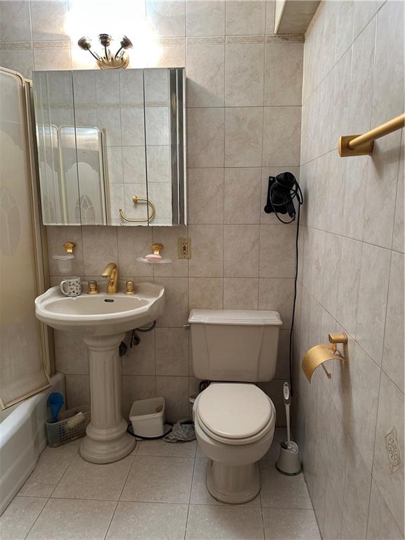 2935 West 5th Street, Unit 6D Brooklyn, NY 11224 - Photo 12 of 13 a bathroom with a toilet sink and mirror