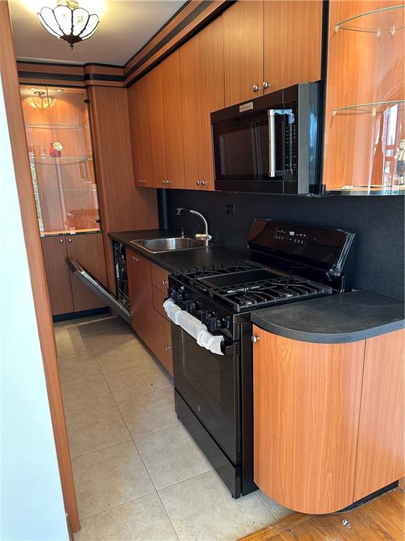2935 West 5th Street, Unit 6D Brooklyn, NY 11224 - Photo 4 of 13 a kitchen with stainless steel appliances granite countertop a stove and a microwave