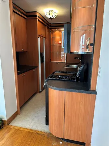 a kitchen with a refrigerator and a stove