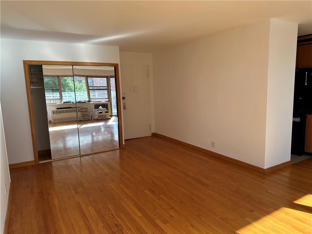 2935 West 5th Street, Unit 6D Brooklyn, NY 11224 - Photo 6 of 13 a view of empty room with wooden floor and fan