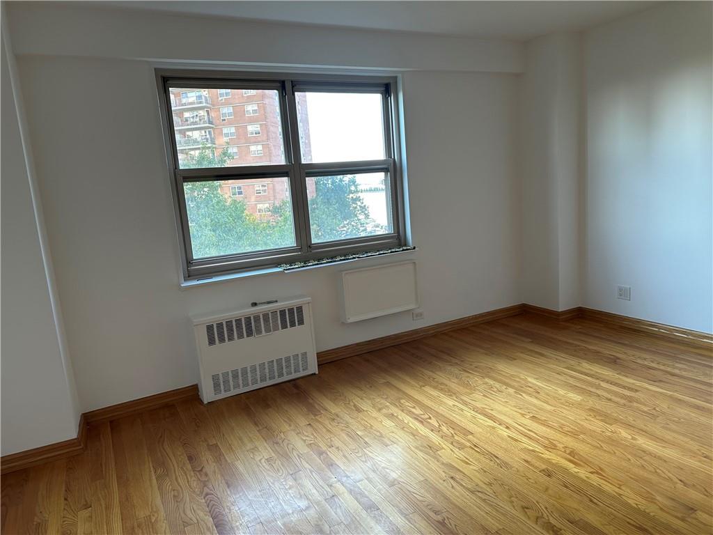 2935 West 5th Street, Unit 6D Brooklyn, NY 11224 - Photo 8 of 13 an empty room with wooden floor and windows