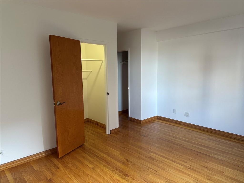 2935 West 5th Street, Unit 6D Brooklyn, NY 11224 - Photo 9 of 13 an empty room with wooden floor and closet