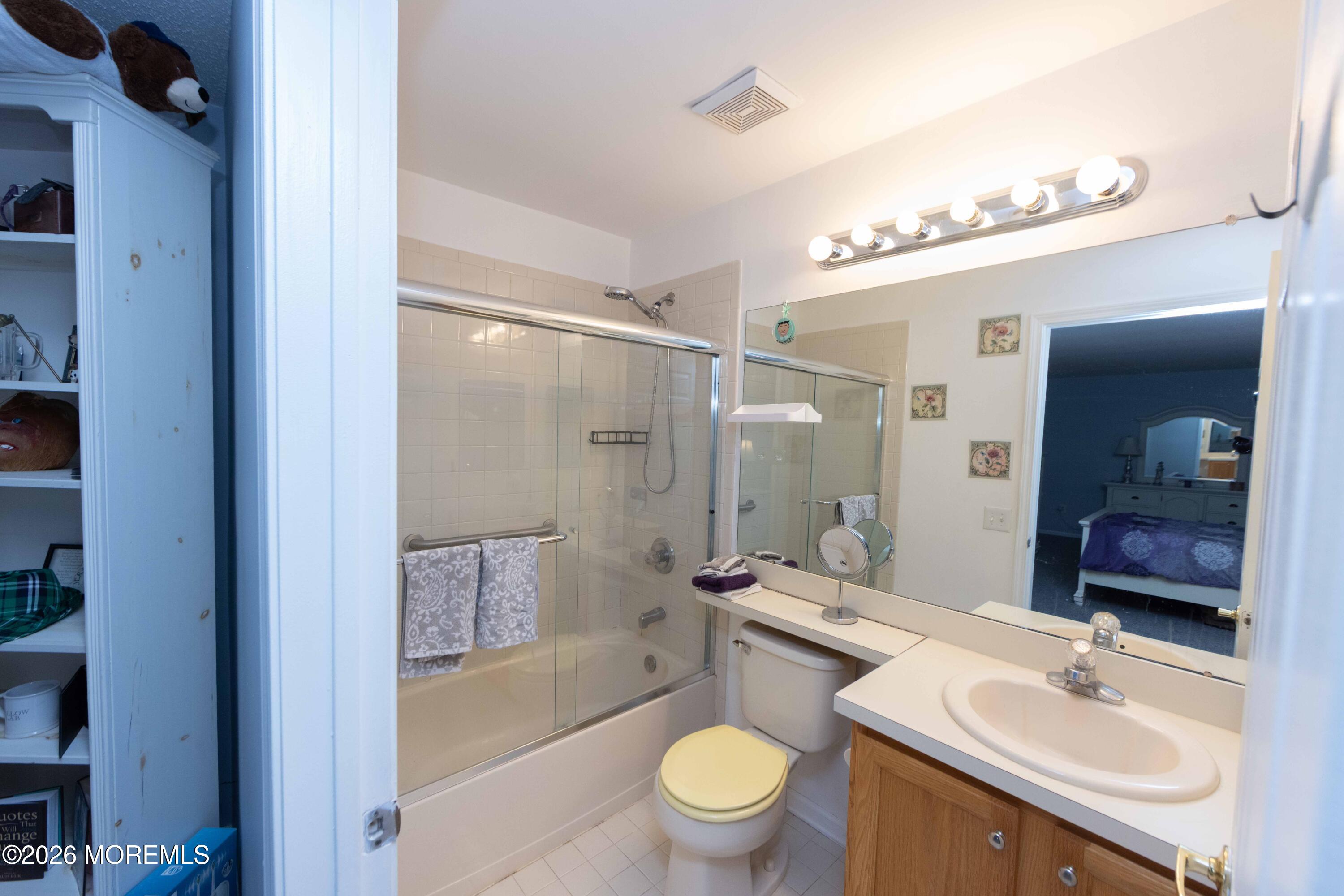 52 Riva Boulevard, Unit 1967 Brick, NJ 08723 - Photo 14 of 15 a bathroom with a sink granite tub toilet and a mirror