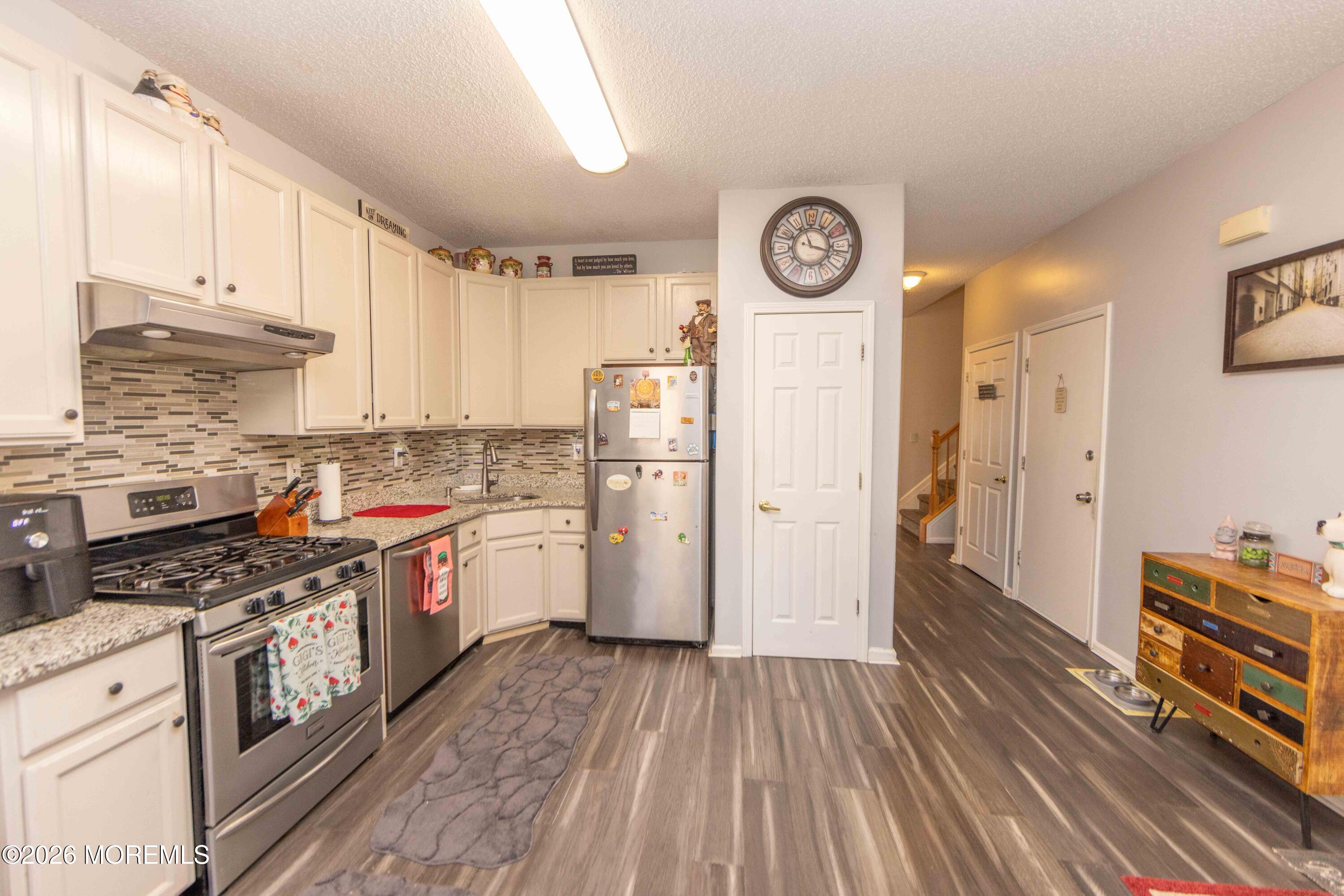 52 Riva Boulevard, Unit 1967 Brick, NJ 08723 - Photo 2 of 15 a kitchen with stainless steel appliances granite countertop a stove and a refrigerator