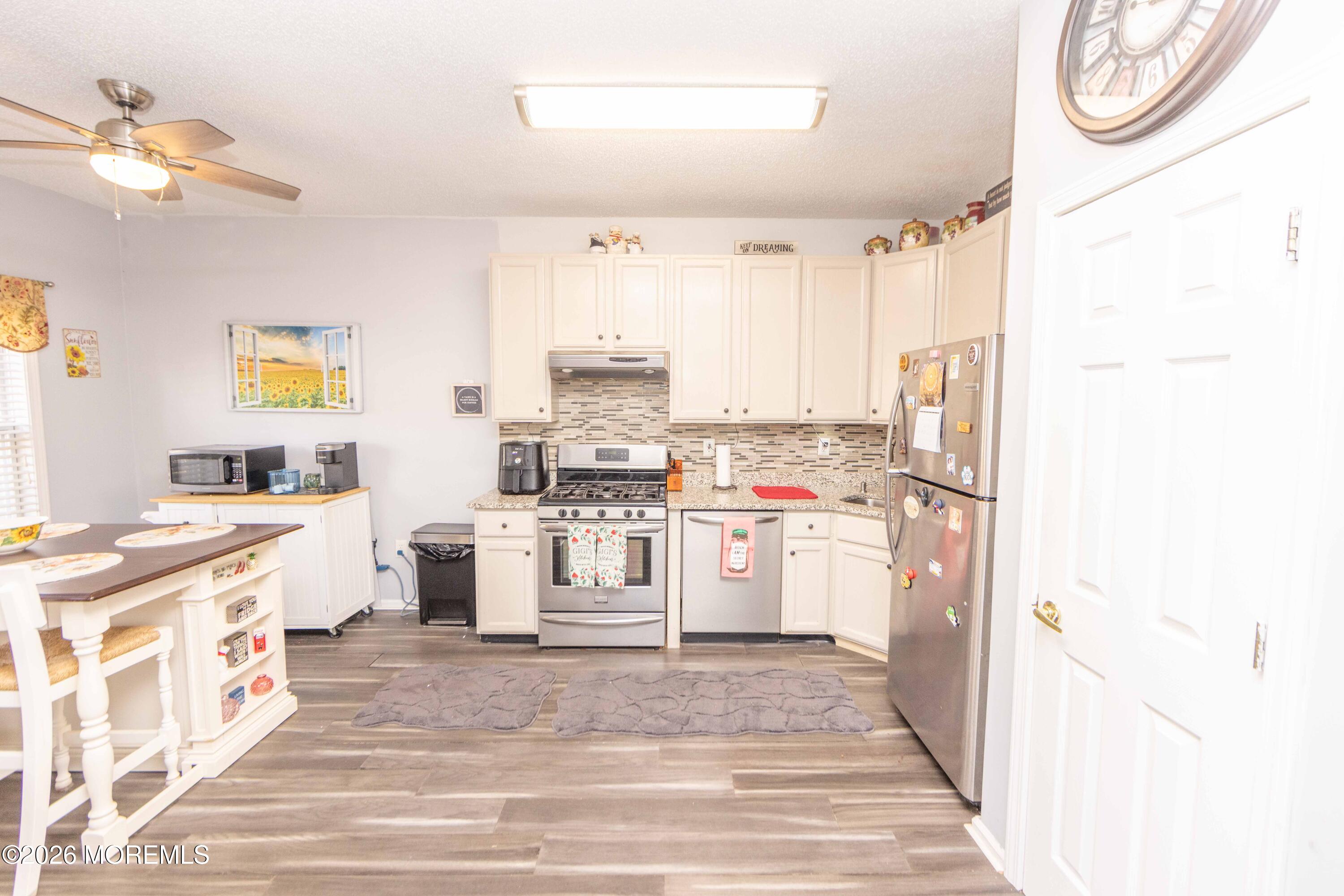 52 Riva Boulevard, Unit 1967 Brick, NJ 08723 - Photo 3 of 15 a kitchen with a refrigerator and a stove
