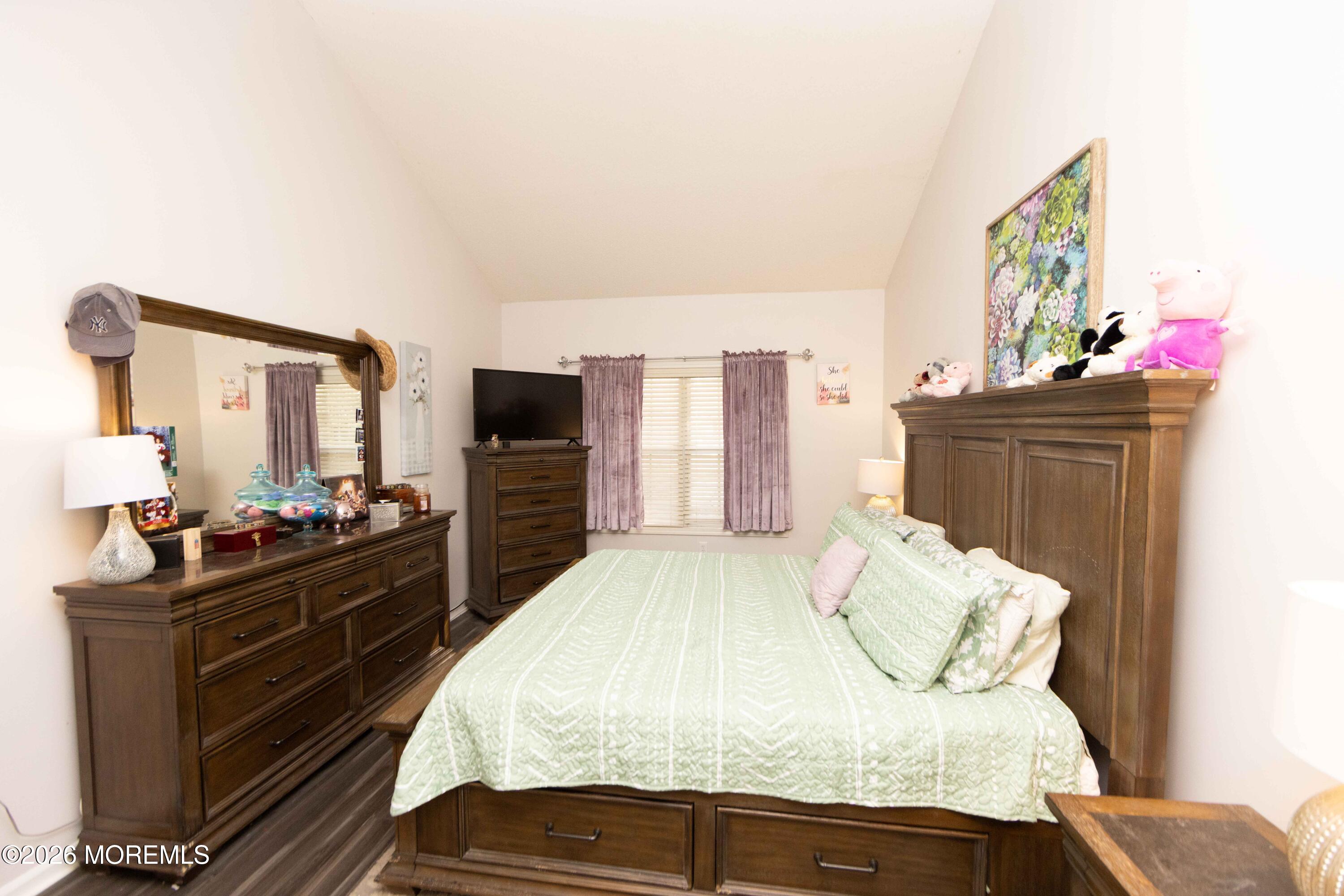 52 Riva Boulevard, Unit 1967 Brick, NJ 08723 - Photo 6 of 15 a bedroom with a bed and flat screen tv