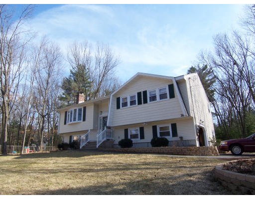 39 Heritage Road Billerica, MA 01821 - Photo 1 of 21 a house that has a tree in front of it