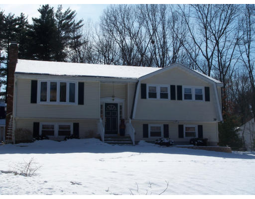 39 Heritage Road Billerica, MA 01821 - Photo 3 of 21 a front view of a house with a yard covered in snow
