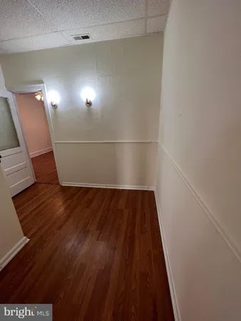 a view of a room with wooden floor