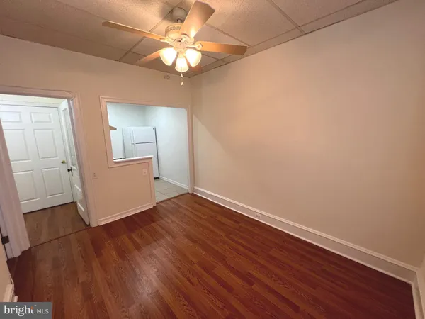an empty room with wooden floor and door