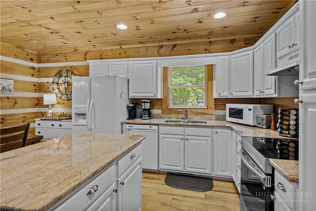 339 Welcome Way Boone, NC 28607 - Photo 8 of 20 a kitchen with stainless steel appliances granite countertop a sink a stove and cabinets