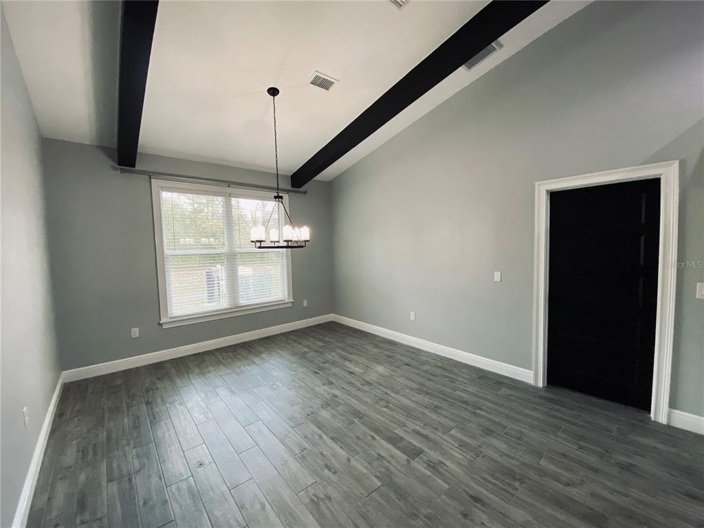 11802 Shadow Run Boulevard Riverview, FL 33569 - Photo 12 of 51 a view of an empty room with wooden floor and windows