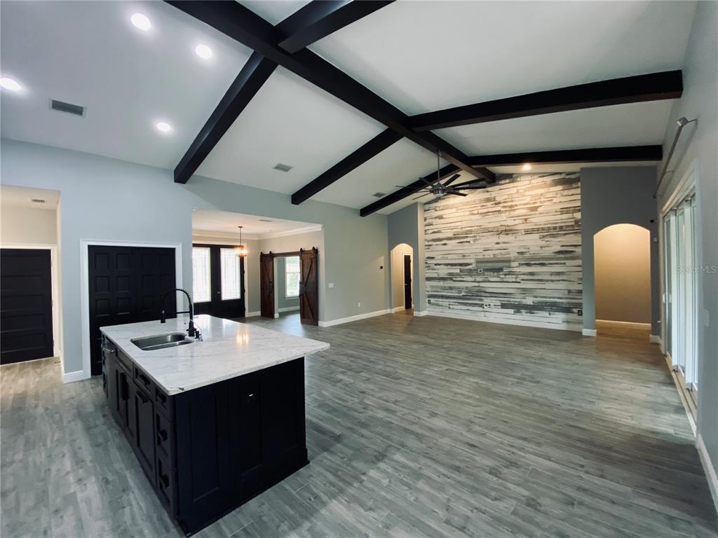 11802 Shadow Run Boulevard Riverview, FL 33569 - Photo 14 of 51 a room with a table chairs and a flat screen tv