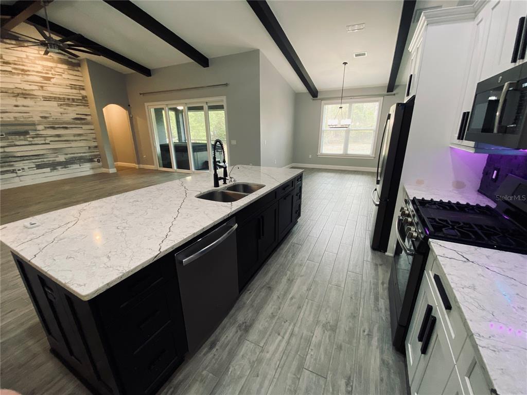 11802 Shadow Run Boulevard Riverview, FL 33569 - Photo 16 of 51 a kitchen with sink and stove