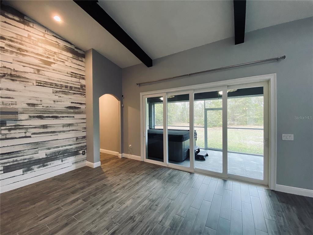 11802 Shadow Run Boulevard Riverview, FL 33569 - Photo 19 of 51 a view of an empty room with wooden floor and a window