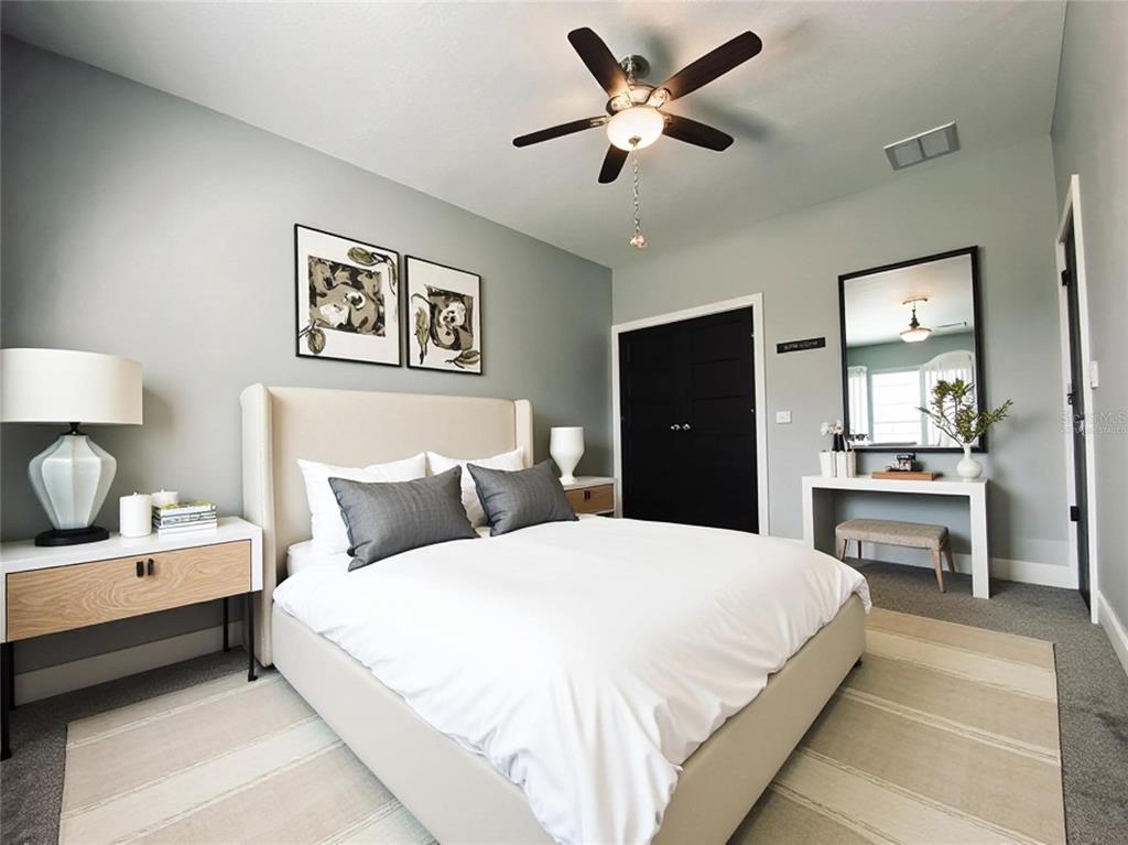 11802 Shadow Run Boulevard Riverview, FL 33569 - Photo 23 of 51 a bedroom with a bed and wooden floor