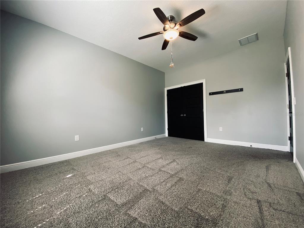 11802 Shadow Run Boulevard Riverview, FL 33569 - Photo 24 of 51 an empty room with a empty space and a ceiling fan