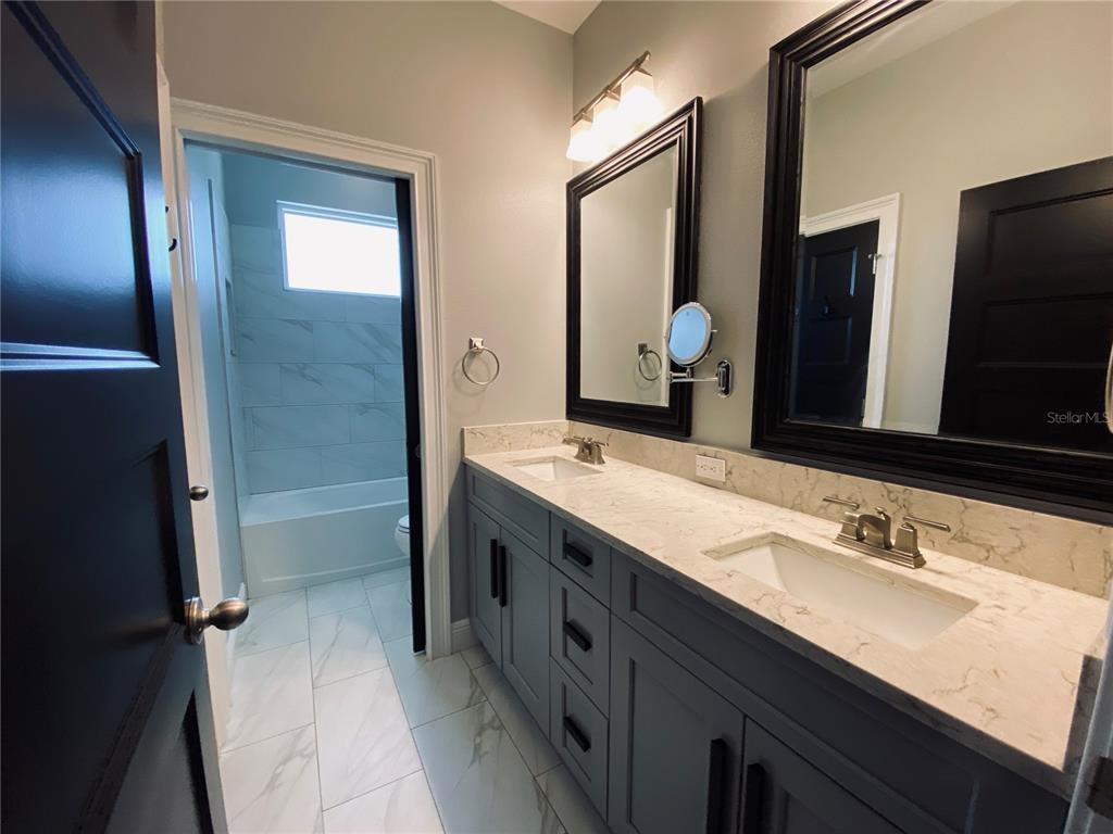 11802 Shadow Run Boulevard Riverview, FL 33569 - Photo 25 of 51 a bathroom with a double vanity sink and mirror