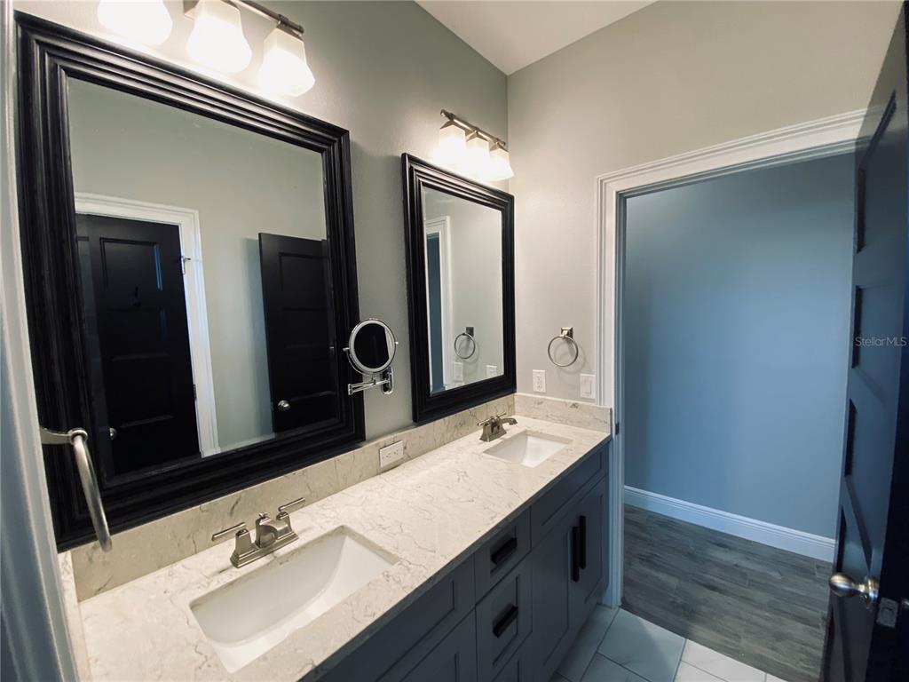 11802 Shadow Run Boulevard Riverview, FL 33569 - Photo 27 of 51 a bathroom with a double vanity sink and a mirror