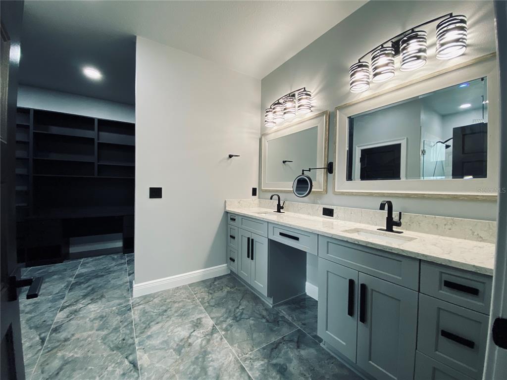 11802 Shadow Run Boulevard Riverview, FL 33569 - Photo 30 of 51 a spacious bathroom with a sink and a mirror