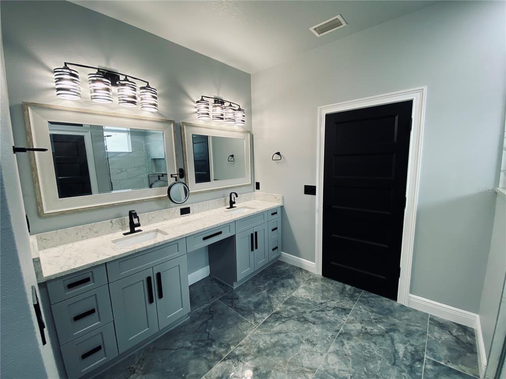 11802 Shadow Run Boulevard Riverview, FL 33569 - Photo 32 of 51 a spacious bathroom with double sink and a mirror