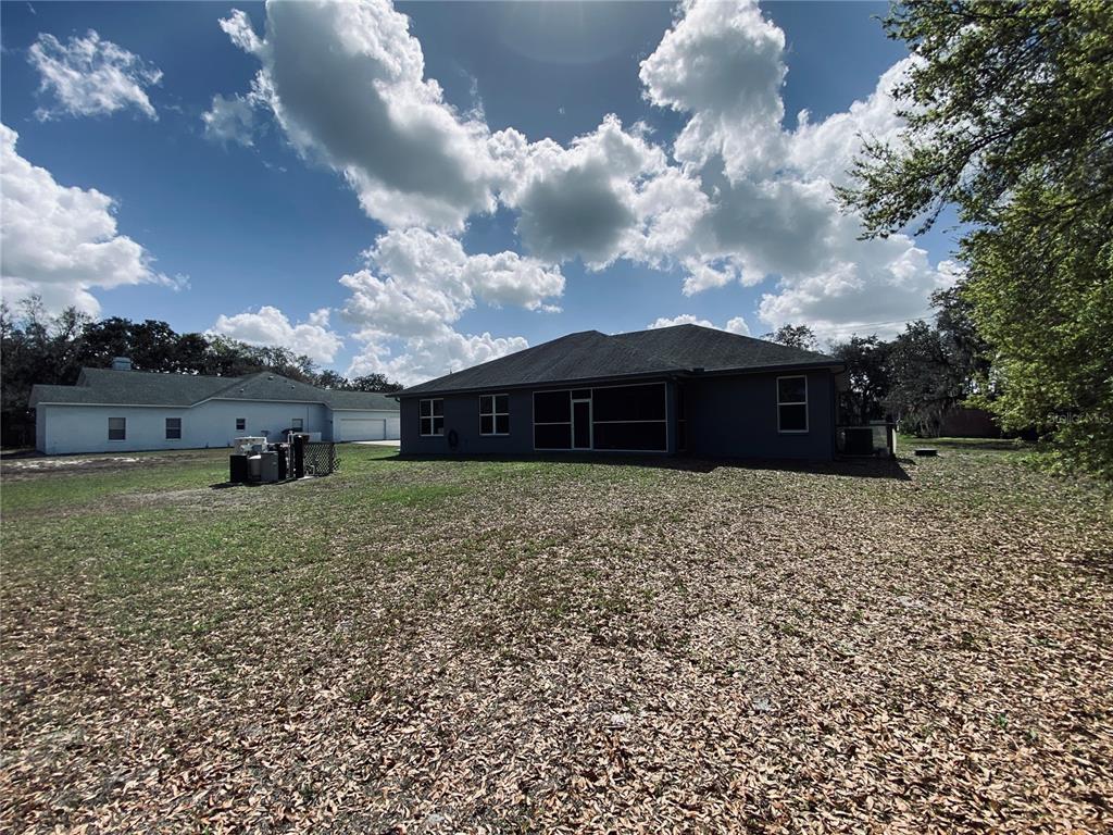11802 Shadow Run Boulevard Riverview, FL 33569 - Photo 48 of 51 a view of a house with a yard and a large tree