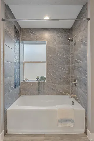 a bathroom with a bathtub and a shower