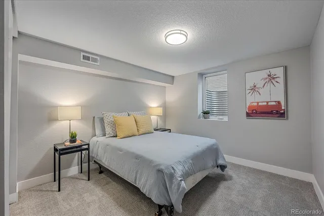 a bedroom with a bed and a night stand