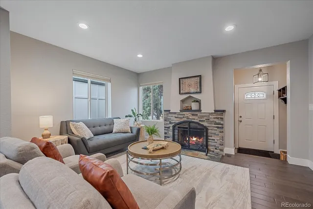 a living room with furniture fireplace and window