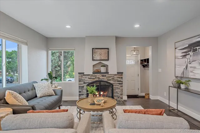 a living room with furniture a window and a fireplace