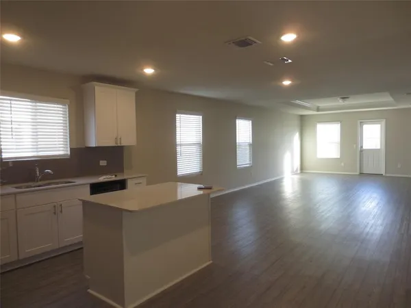 a kitchen with refrigerator and cabinets