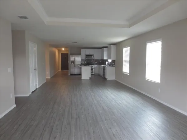 a kitchen with kitchen island granite countertop a sink cabinets and stainless steel appliances