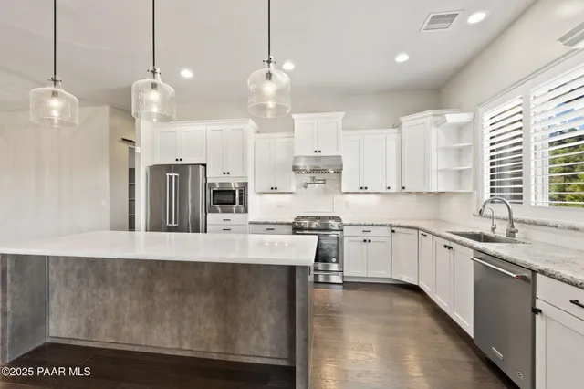 a spacious bathroom with a double vanity sink a mirror and a bathtub
