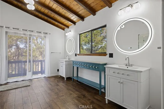 a bathroom with a toilet a sink and a large mirror