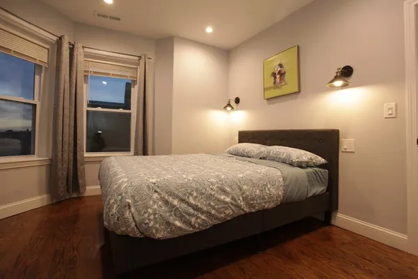 a bed sitting in a bedroom next to a window