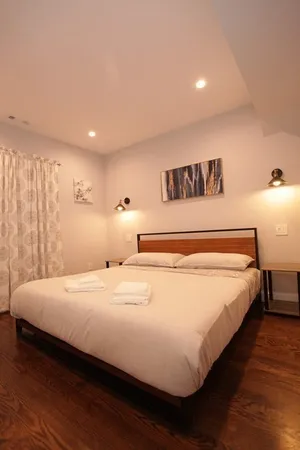 a bedroom with a bed and a night stand