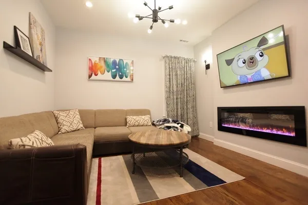 a living room with furniture a rug and a fireplace