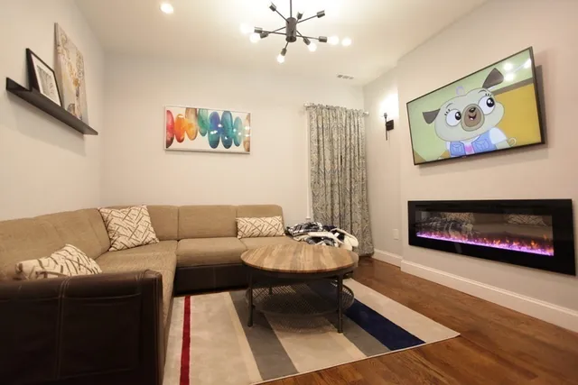 a living room with furniture a rug and a fireplace