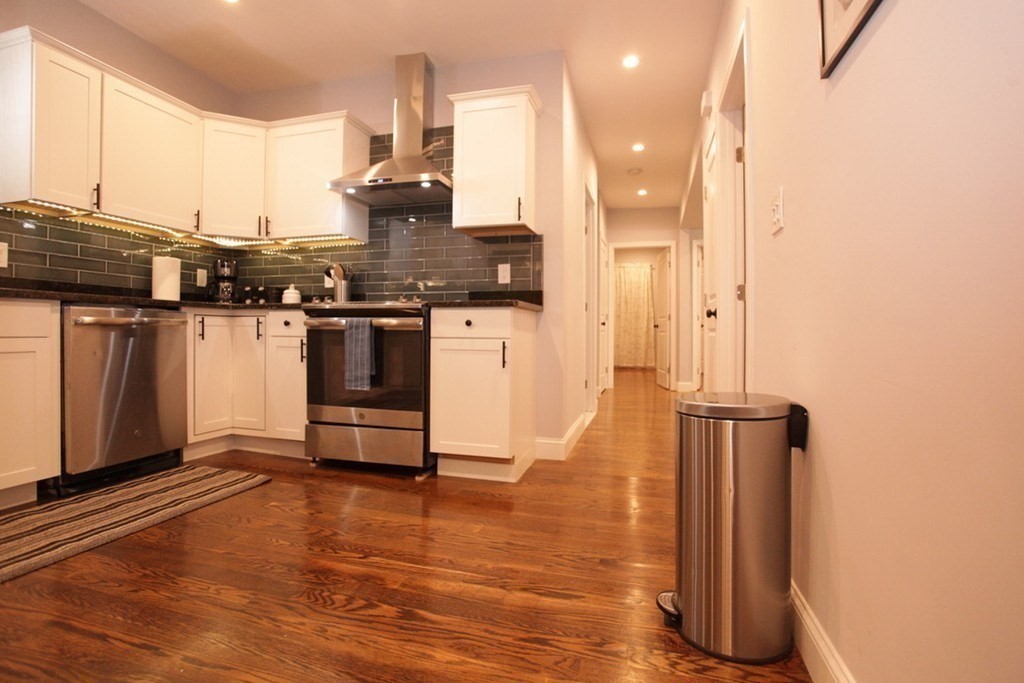 289-291 Main Street, Unit 3 Everett, MA 02149 - Photo 6 of 6 a kitchen with stainless steel appliances granite countertop a refrigerator and a stove