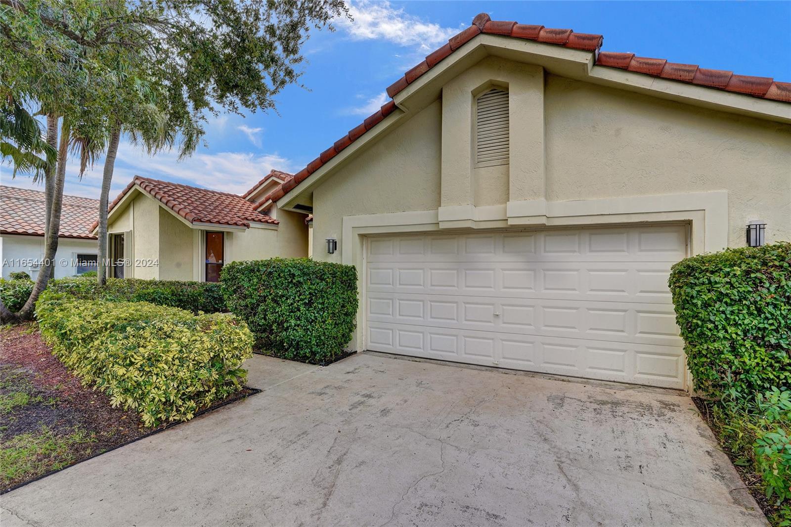 22200 Cranbrook Road Boca Raton, FL 33428 - Photo 3 of 80 a front view of a house with garden