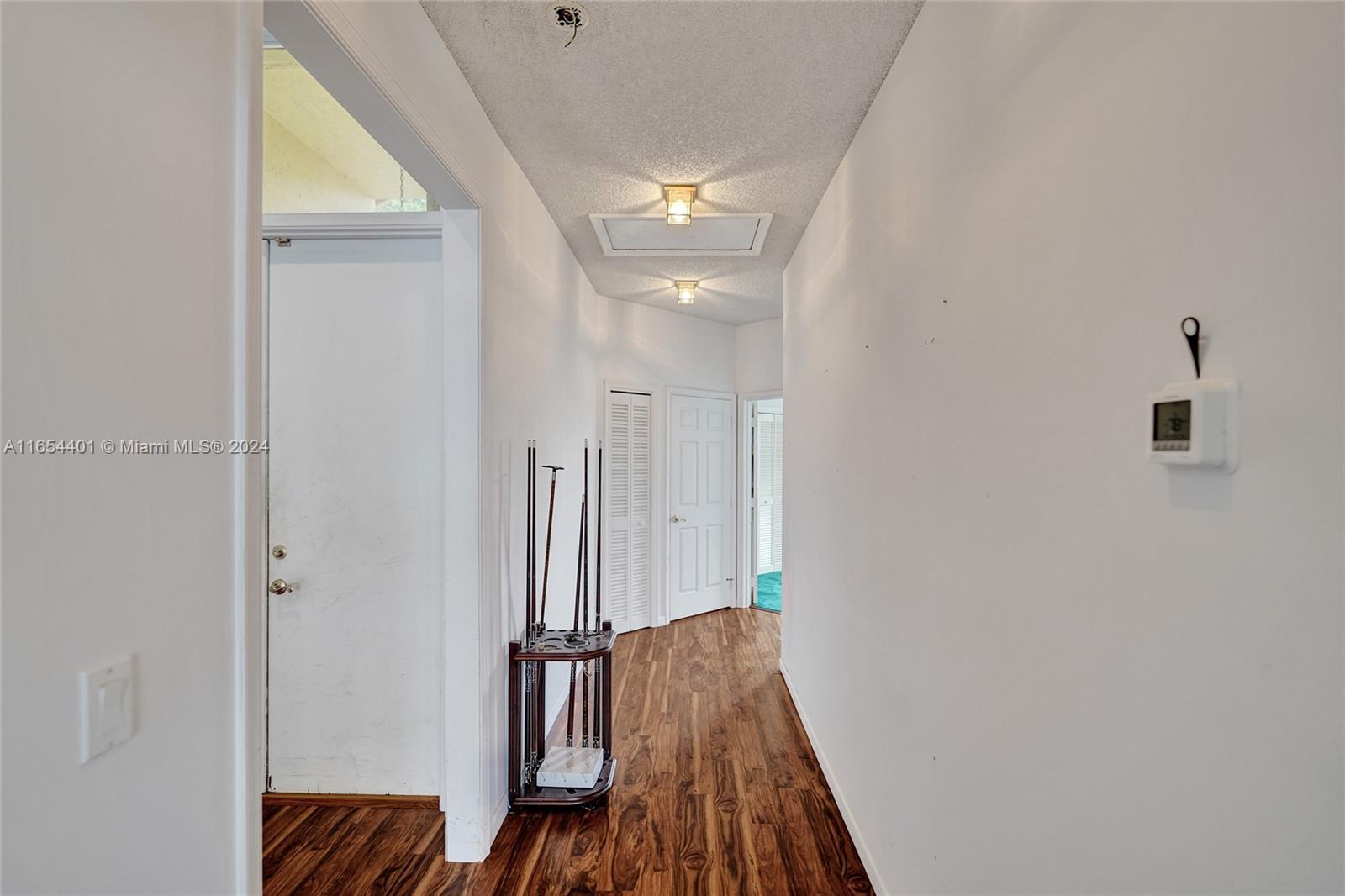 22200 Cranbrook Road Boca Raton, FL 33428 - Photo 54 of 80 a view of a hallway with wooden floor and staircase