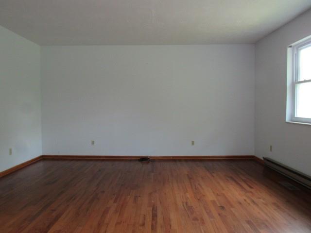 382 Walnut Hill Road Uniontown, PA 15401 - Photo 6 of 22 an empty room with wooden floor and windows