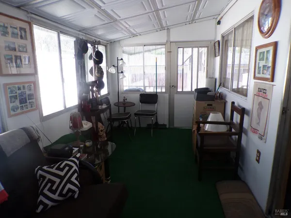 a living room with furniture and a floor to ceiling window