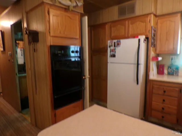 a white refrigerator freezer sitting in a kitchen