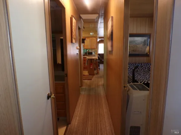 a view of hallway with wooden floor