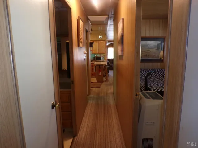 a view of hallway with wooden floor