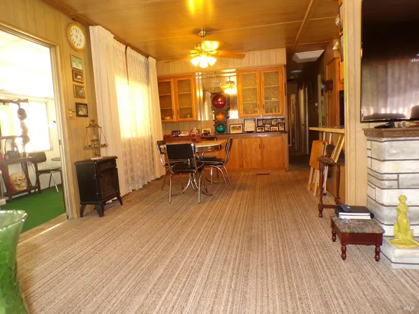 a view of a living room with furniture and wooden floor